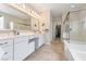 Spacious bathroom boasts double sinks, a large mirror, separate shower and tub, and walk-in closet at 9288 Valley Betica Ave, Las Vegas, NV 89148