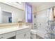 Well-lit bathroom featuring a vanity with a white countertop, a bathtub with a shower, and modern fixtures at 9288 Valley Betica Ave, Las Vegas, NV 89148