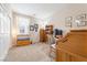Bright bedroom featuring a wooden desk, bookshelf, and comfortable carpeting, perfect for a home office or study at 9288 Valley Betica Ave, Las Vegas, NV 89148