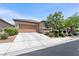 Charming home featuring a two-car garage and desert landscaping, complemented by a concrete driveway at 9288 Valley Betica Ave, Las Vegas, NV 89148