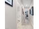 Clean hallway showcasing neutral wall colors and tile flooring, with doorways providing glimpses into the rooms, creating a cohesive feel at 9288 Valley Betica Ave, Las Vegas, NV 89148