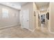 Bright hallway featuring neutral-toned walls and tile flooring, leading to various rooms enhancing a sense of openness at 9288 Valley Betica Ave, Las Vegas, NV 89148