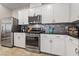 Modern kitchen boasts stainless steel appliances, sleek black countertops, and stylish backsplash at 9288 Valley Betica Ave, Las Vegas, NV 89148