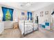 Comfortable bedroom with large windows and a ceiling fan at 9288 Valley Betica Ave, Las Vegas, NV 89148
