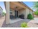 Inviting covered patio with outdoor furniture, ceiling fan, grill, and beautifully landscaped backyard at 9288 Valley Betica Ave, Las Vegas, NV 89148