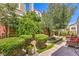 Private backyard with decorative fountain and lush, manicured landscaping at 979 Coatbridge St, Las Vegas, NV 89145