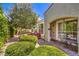 Relaxing backyard featuring a covered patio, green bushes, and a cozy seating area at 979 Coatbridge St, Las Vegas, NV 89145