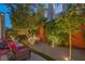 Cozy backyard with gravel, small trees, patio furniture, and beautiful decorative lighting at 979 Coatbridge St, Las Vegas, NV 89145