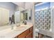 Bathroom with single sink vanity and a shower-tub combo with colorful curtain at 979 Coatbridge St, Las Vegas, NV 89145