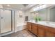 Bright bathroom featuring a tub, shower, and double sink vanity with a large mirror at 979 Coatbridge St, Las Vegas, NV 89145