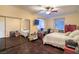 Bedroom with a ceiling fan, a mirrored closet, and wood-look flooring at 979 Coatbridge St, Las Vegas, NV 89145