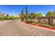 Paver entrance to neighborhood, with mature trees, shrubs, and a decorative community sign at 979 Coatbridge St, Las Vegas, NV 89145
