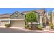 Charming exterior of a home with a two-car garage and a well-maintained front yard at 979 Coatbridge St, Las Vegas, NV 89145