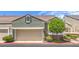 Charming townhouse featuring a two-car garage and well-maintained landscaping at 979 Coatbridge St, Las Vegas, NV 89145