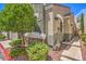 The front exterior of the home features stone accents, lush landscaping, and a well-lit walkway at 979 Coatbridge St, Las Vegas, NV 89145