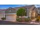 Charming townhome features a two-car garage, desert landscaping, and stone accents for added curb appeal at 979 Coatbridge St, Las Vegas, NV 89145