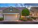Charming townhome features a two-car garage, desert landscaping, and stone accents for added curb appeal at 979 Coatbridge St, Las Vegas, NV 89145
