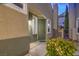Charming front entrance with a green door, stylish lighting, and manicured landscaping at 979 Coatbridge St, Las Vegas, NV 89145