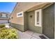 Exterior front entrance features a stylish front door, updated lighting, and manicured landscaping at 979 Coatbridge St, Las Vegas, NV 89145