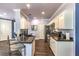 Modern kitchen with granite countertops, stainless steel appliances, and dark wood-look flooring at 979 Coatbridge St, Las Vegas, NV 89145