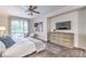 The main bedroom features wood-look floors, a ceiling fan, and access to the backyard at 979 Coatbridge St, Las Vegas, NV 89145