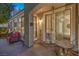Cozy outdoor patio with seating area, lush landscaping, and a sliding glass door to the interior at 979 Coatbridge St, Las Vegas, NV 89145