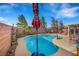 Stunning backyard pool surrounded by lush greenery and comfortable seating, creating a perfect outdoor retreat at 1068 African Eagle Ave, Henderson, NV 89015