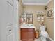 Modern half-bath features a cherry vanity and matching fixtures at 1068 African Eagle Ave, Henderson, NV 89015