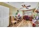 Comfortable bedroom featuring wood floors, ceiling fan and bright lighting at 1068 African Eagle Ave, Henderson, NV 89015
