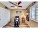 Neutral bedroom featuring wood floors, ceiling fan, and a window at 1068 African Eagle Ave, Henderson, NV 89015