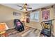 Neutral bedroom featuring wood floors, ceiling fan, and a window at 1068 African Eagle Ave, Henderson, NV 89015