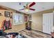 Neutral bedroom featuring wood floors, ceiling fan and sports decor at 1068 African Eagle Ave, Henderson, NV 89015