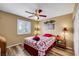 Cozy bedroom with ceiling fan, wood-look flooring, and window providing natural light at 1068 African Eagle Ave, Henderson, NV 89015
