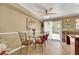 Bright eat-in kitchen with a dining table, backyard access, and tan tile flooring at 1068 African Eagle Ave, Henderson, NV 89015