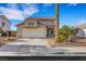 Charming single-Gathering home showing landscaping, rock mulch, and the two car garage, a relaxing desert vibe at 1068 African Eagle Ave, Henderson, NV 89015