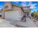 Front exterior showcasing desert landscaping, palm trees and a two-car garage, with a charming entry at 1068 African Eagle Ave, Henderson, NV 89015