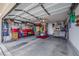Spacious garage featuring ample storage, with overhead door, shelving units, and access to the home at 1068 African Eagle Ave, Henderson, NV 89015