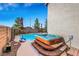Backyard showcasing a hot tub with wooden steps and landscaped surroundings, perfect for relaxation at 1068 African Eagle Ave, Henderson, NV 89015