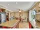 View of the kitchen island, dining table, and backyard access with pool views at 1068 African Eagle Ave, Henderson, NV 89015