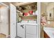 Convenient laundry area with washer, dryer, and shelving for storage at 1068 African Eagle Ave, Henderson, NV 89015