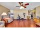 Spacious living room with hardwood floors, ceiling fan, and comfortable seating area at 1068 African Eagle Ave, Henderson, NV 89015