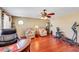 Inviting living room with hardwood floors, comfortable seating, a ceiling fan, and abundant natural light at 1068 African Eagle Ave, Henderson, NV 89015