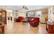 Bright living room featuring tile flooring, a ceiling fan, natural light, and cozy furniture at 1068 African Eagle Ave, Henderson, NV 89015