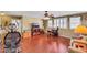 Spacious living room with hardwood floors, ceiling fan, ample seating, and a dedicated workspace at 1068 African Eagle Ave, Henderson, NV 89015