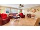 Inviting living room featuring tile flooring, a ceiling fan, and natural light with comfortable furniture at 1068 African Eagle Ave, Henderson, NV 89015
