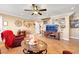 Inviting living room featuring tile flooring, a ceiling fan, and comfortable seating with a staircase at 1068 African Eagle Ave, Henderson, NV 89015