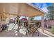 Inviting covered patio area featuring outdoor seating, providing a perfect space for relaxation and entertainment at 1068 African Eagle Ave, Henderson, NV 89015