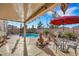 Backyard patio with landscaping, patio furniture and a pool, perfect for relaxing and entertaining at 1068 African Eagle Ave, Henderson, NV 89015