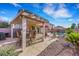 Charming covered patio provides comfortable seating and dining space adjacent to the sparkling pool at 1068 African Eagle Ave, Henderson, NV 89015