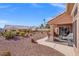 Inviting backyard with a covered patio and desert landscaping, ideal for outdoor entertaining at 10921 Grand Haven Ave, Las Vegas, NV 89134